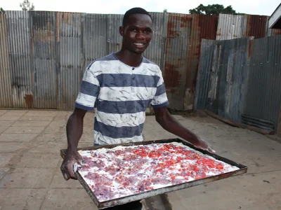 Ein Junge trägt ein Blech mit einem Flammkuchen / Zwiebelweihe